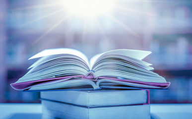 Wall Mural - Stack of books in the library and blur bookshelf background	
