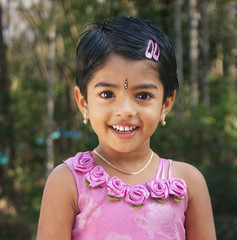 Closeup of beautiful cute happy child girl, looking at the camera with a big smiley face. Being Optimistic In life