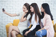 © natara - Three young happy women friends taking a selfie