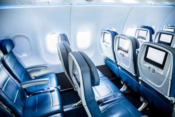 Interior of an empty airplane. View from the back of the plane. Nobody on the plane. Abstract air travel photo.