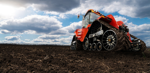 Autocollant - Rubber tracked agricultural tractor on a field.