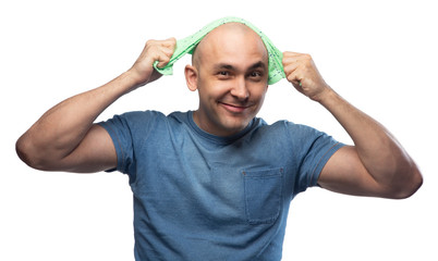 Wall Mural - Portrait of young bald man polishing his head