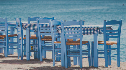 Open cafe outdoor restaurant in Greece on sea shore