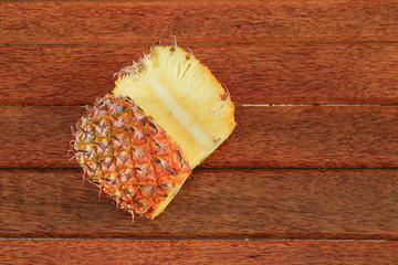 Wall Mural - sliced pineapple fruit isolated on wooden background