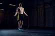 Athletic young man training with skipping rope. Cardio workout with minimal equipment