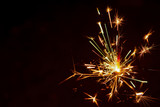 Fototapeta Sypialnia - Sparkler background. Christmas and new year sparkler holiday background..
