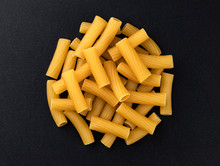 Raw Spiral Tortiglioni Pasta Isolated On Black Background, Top View
