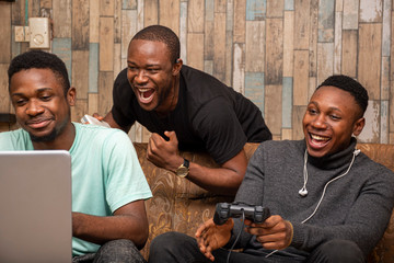 young african friends playing video games together