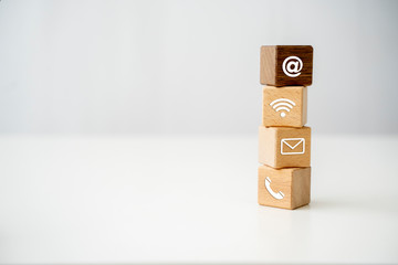 Wooden block cube symbol telephone, email, address, Wifi, Website page contact us or e-mail marketing digital customer call service tablet computer and mobile smartphone, business concept