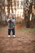 © Aleksei Zakharov - a boy in a gray warm vest and a gray cap plays games in the open air against the background