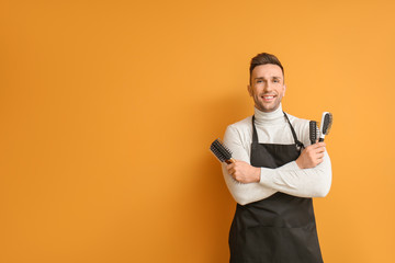 Wall Mural - Male hairdresser on color background