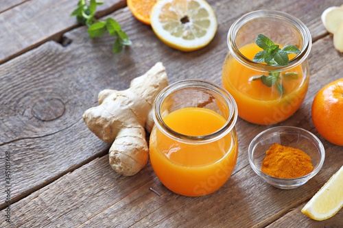 Ginger shot with citrus fruits juice, turmeric and honey. Pure vegan Immunity system booster. Copy space