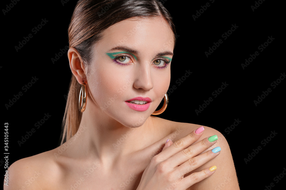 Young woman with beautiful manicure on dark background