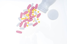 Pills Spilling Out Of Pill Bottle. Assorted Pharmaceutical Medicine Pills, Tablets And Capsules On White Background. Antiretrovirals On White Background.