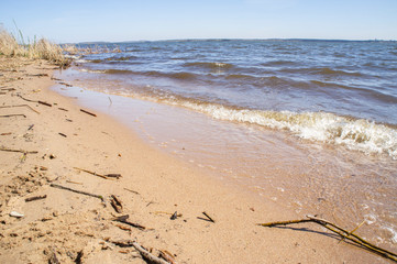 Golden sandy seashore with transparent wave