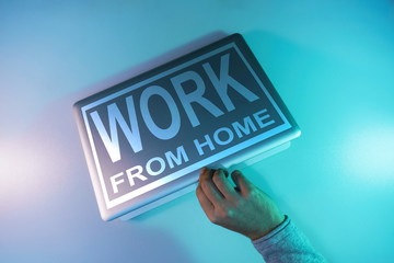 Aufkleber - Words work from home on a  silver laptop night online in the color light on a table night background.  Top view.