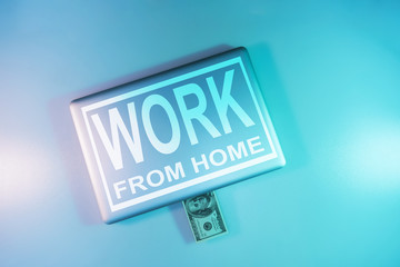 Aufkleber - Words work from home on a  cloused silver laptop and 100 dollars night online in the color light on a table night background. Top view.