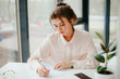 © Катя Іваськевич - portrait of young businesswoman working  in the office. business woman writes.