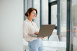 © Катя Іваськевич - portrait of young businesswoman working on laptop in the office.