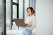 © Катя Іваськевич - portrait of young businesswoman working on laptop in the office.