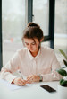 © Катя Іваськевич - portrait of young businesswoman working  in the office. business woman writes.