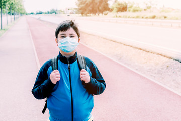 Child with a mask on his face to protect himself from the coronavirus.