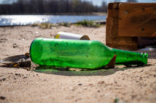 Old Discarded Empty Green Bottle And Tin Can