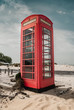 An old, traditional, British red telephone box on the sandy beach at Shell Bay, Isle of Purbeck, near Sandbanks, Dorset, England, UK