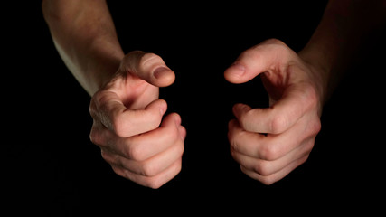 Wall Mural - Human male palm clench a fist isolated on black background. Close up.