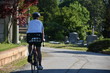 Man riding a bike in a cemetery 