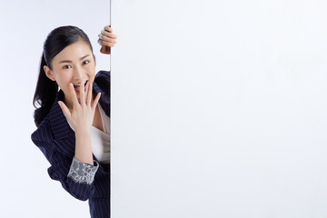 business woman presenting a blank billboard on white background. Advertising concept