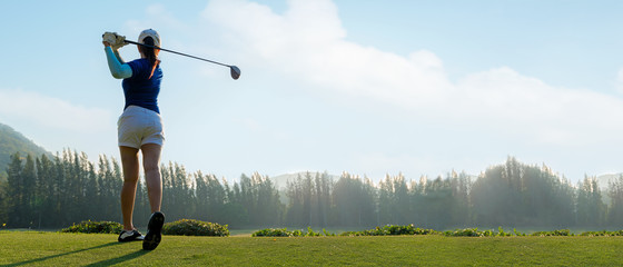 Wall Mural - Golfer sport course golf ball fairway. People lifestyle woman playing game golf tee of on the green grass sunset background. Asia female player game shot in summer. copy space and banner