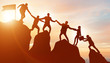 © Elnur - Concept of teamwork with team climbing mountain top