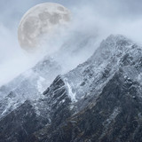 Fototapeta Na ścianę - Epic digital composite image of Supermoon above mountain range giving very surreal fantasy look to the dramatic landscape image