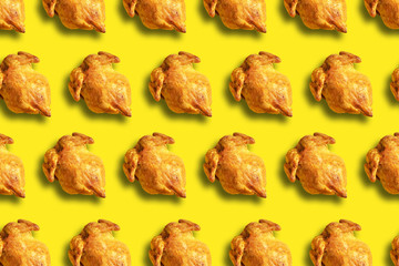 Wall Mural - colorful pattern of roasted chicken or turkey on yellow background. top view. creative design for pa