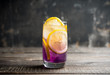 Gin based colorful cocktail with lemon and lavender liqueur on the rustic background. Selective focus. Shallow depth of field.
