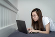 © dieprince - Asian woman wear white T-Shirt is working from home during coronavirus or COVID-19  with laptops and computers, quarantine for coronavirus