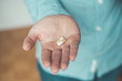 © Patrick Daxenbichler - Medicament or cure concept. Close up of male hand with pills.