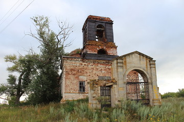 abandoned red brick church in the grass