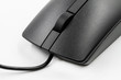 © marketlan - A part of black optical cable computer mouse on white background. Closeup