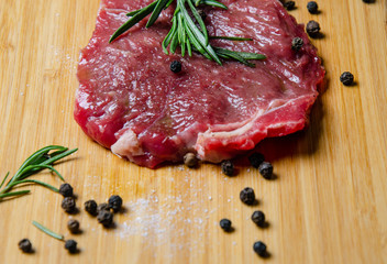 steak, rosemary and salt on a serving board