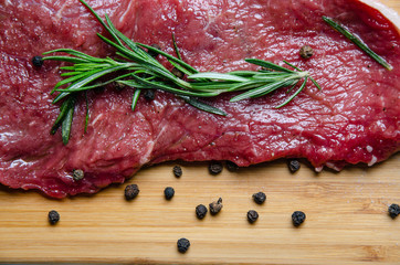 steak, rosemary and salt on a serving board