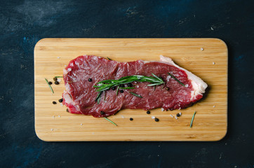 steak, rosemary and salt on a serving board