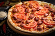 © Oleksandr - pizza with bavarian sausages, tomato and chili pepper on dark background