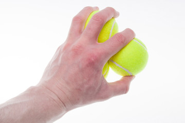 Tennis balls in the man's hand isolated on the white