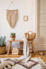 Wall Mural - stylish composition of living room interior with mock up frame, wooden bench, pillow, plaid, woman b