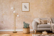 © FollowTheFlow - Stylish concept of living room interior with gold lamp, design grey sofa, mock up picture frame, books, plant, carpet, rattan pouf, pillow, plaid and elegant accessories in home decor.