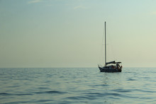 A Lone Boat Floating On A Calm Sea. Tint