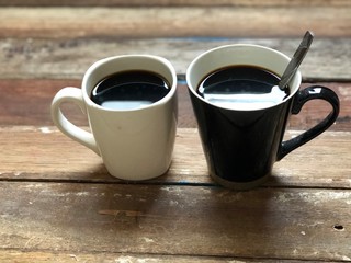 Espresso,black coffee in mug on empty old wood table top,dimly light,with lens flare,free space for text design.2 Coffee cup for couple of love,friend etc.Concept of Relaxation in Coffee time.