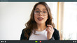 Indoor shot of energetic attractive young female manager in eyeglasses talking to colleagues online during video conference call while working from home, social distancing, using modern technology